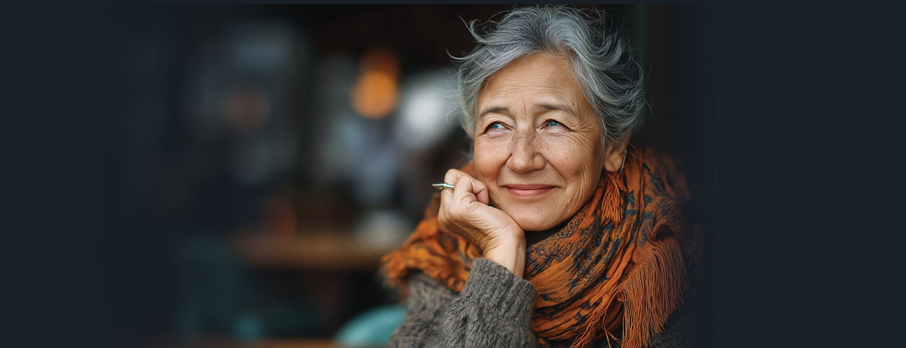 woman wearing an orange scarf and smiling